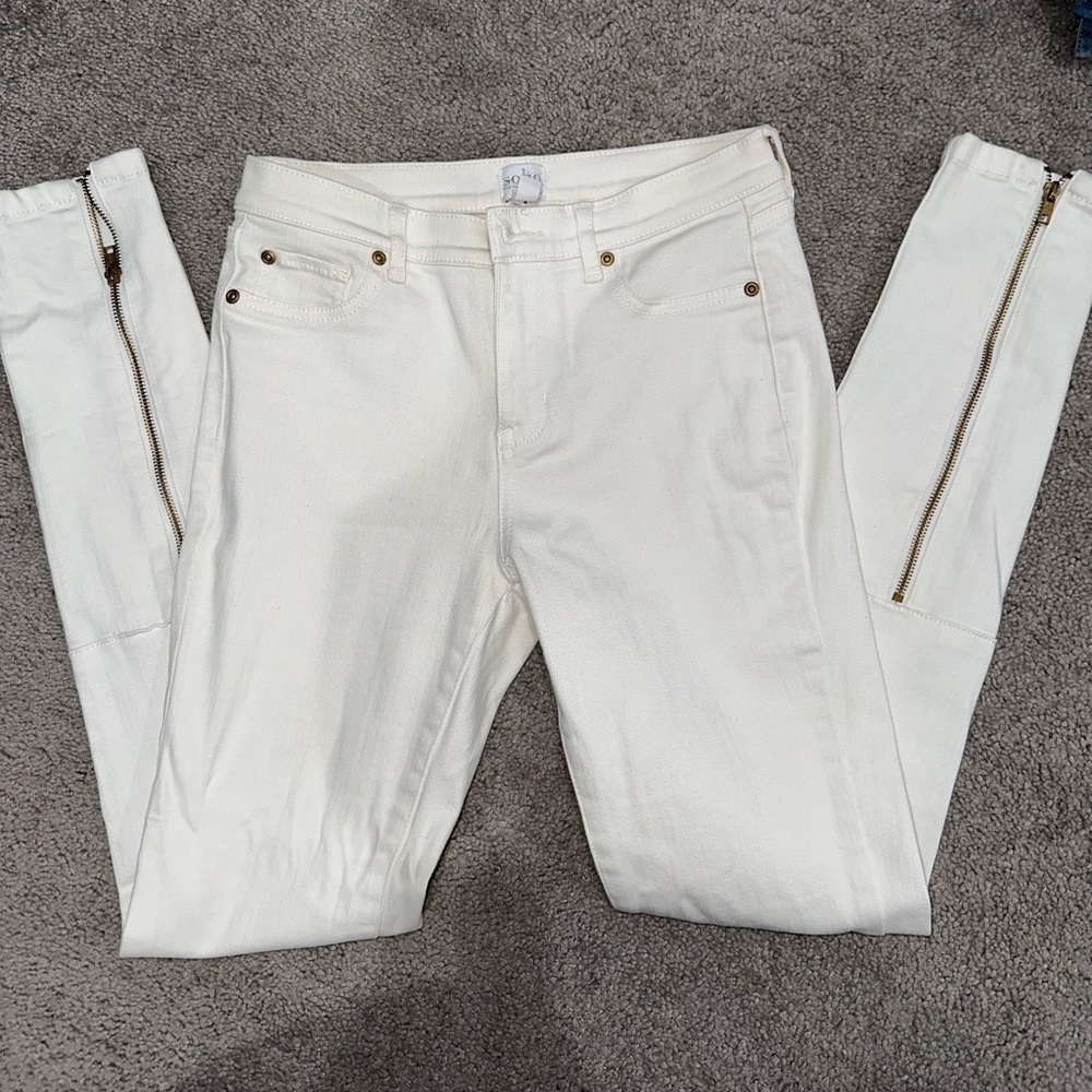 Skinny white jeans with gold zips on back pants